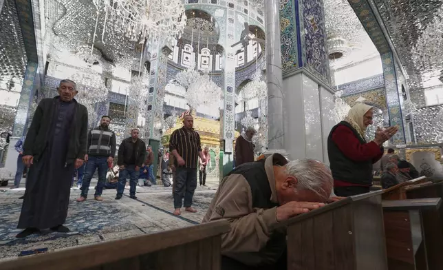 Worshippers pray at the Sayyida Zeinab shrine where many Shiite believe Zeinab, the granddaughter of Prophet Muhammad is entombed, in Sayyida Zeinab, south of Damascus, Syria, Saturday March 15, 2025.(AP Photo/Omar Sanadiki