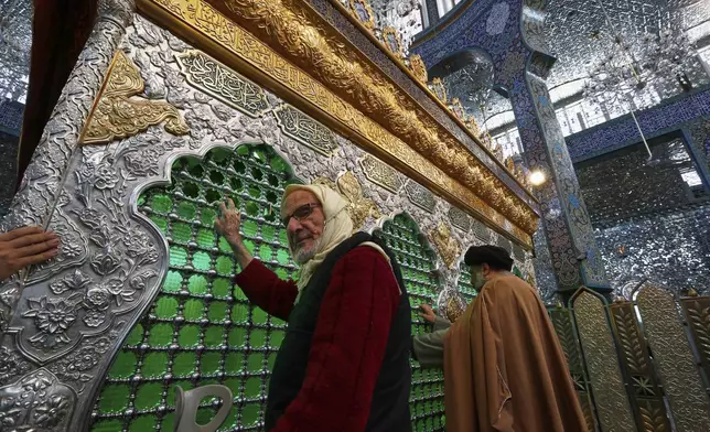 Shiite worshippers pray at the Sayyida Zeinab shrine where many Shiite Muslims believe Zeinab, the granddaughter of Prophet Muhammad is entombed, in Sayyida Zeinab, south of Damascus, Syria, Saturday March 15, 2025.(AP Photo/Omar Sanadiki)