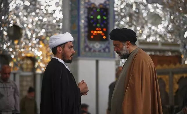 Shiite clergy speak at the Sayyida Zeinab Shrine, where many Shiite Muslims believe Zeinab, the granddaughter of Prophet Muhammad, is entombed, in Sayyida Zeinab, south of Damascus, Syria, Saturday, March 15, 2025. (AP Photo/Omar Sanadiki)