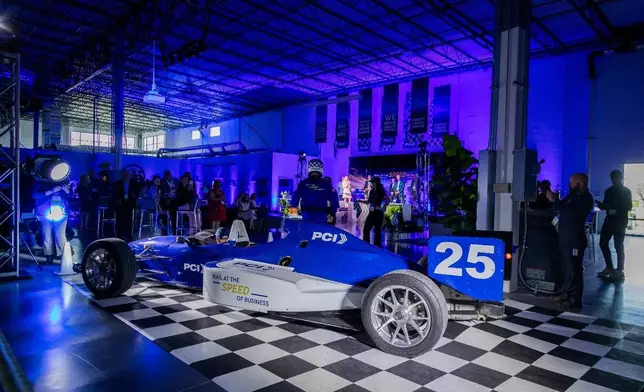 William “Bill” Levinson, PCI’s VP of Operations, arrives with the ceremonial scissors at the PCI Midwest Grand Opening and Ribbon-Cutting Ceremony in an actual two-seater Indy 500 racecar. (Photo: BERNARDOFOTO)