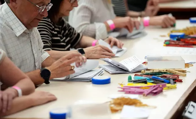 Votes are counted at Grimsby Town Hall, in Lincolnshire, for the Greater Lincolnshire Mayor election, Thursday, May 1, 2025. (Joe Giddens/PA via AP)
