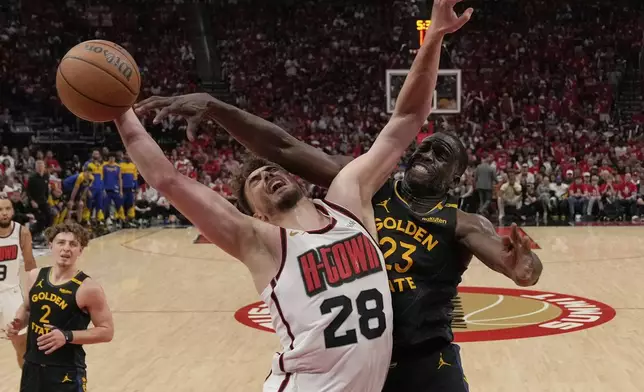Houston Rockets' Alperen Sengun (28) goes up for a shot as Golden State Warriors' Draymond Green (23) defends during the second half of Game 7 of an NBA basketball first-round playoff series Sunday, May 4, 2025, in Houston. (AP Photo/Ashley Landis)