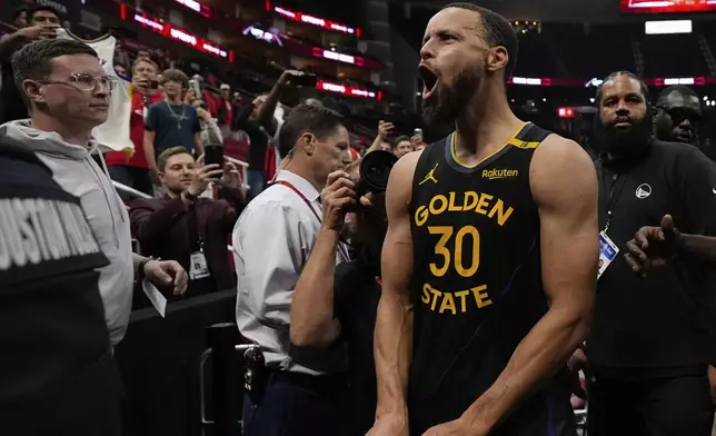 Golden State Warriors' Stephen Curry (30) celebrates after Game 7 of an NBA basketball first-round playoff series against the Houston Rockets Sunday, May 4, 2025, in Houston. (AP Photo/Ashley Landis)