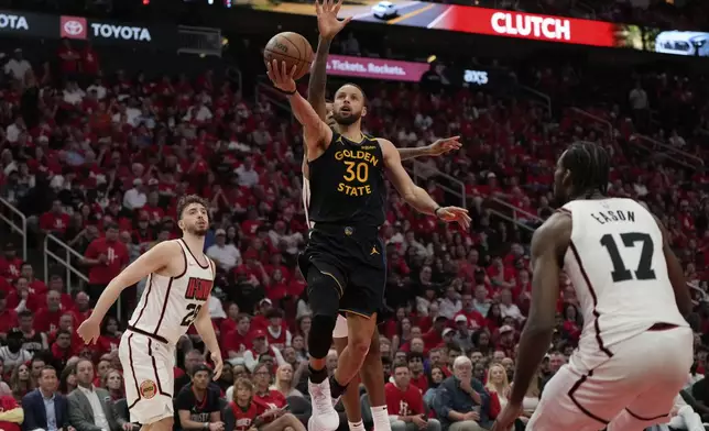 Golden State Warriors' Stephen Curry (30) goes up for a shot as Houston Rockets' Jabari Smith Jr. rear, defends during the second half of Game 7 of an NBA basketball first-round playoff series Sunday, May 4, 2025, in Houston. (AP Photo/Ashley Landis)