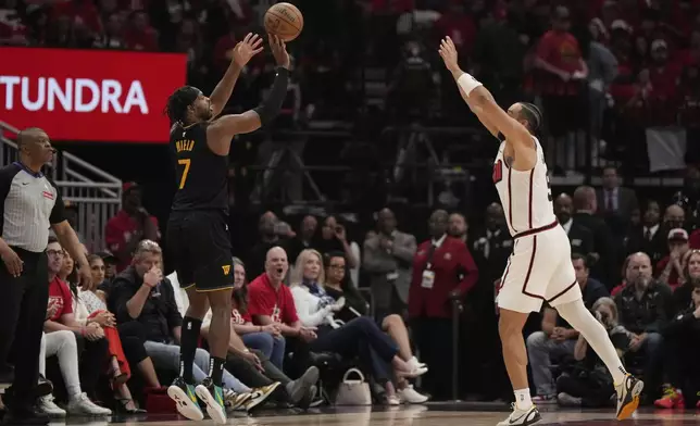 Golden State Warriors' Buddy Hield (7) shoots a three-pointer as Houston Rockets' Dillon Brooks (9) defends during the first half of Game 7 of an NBA basketball first-round playoff series Sunday, May 4, 2025, in Houston. (AP Photo/Ashley Landis)