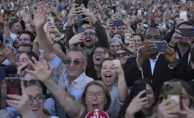 People react as the newly elected Pope Leo XIV appears on the balcony of St. Peter's Basilica at the Vatican, Thursday, May 8, 2025. (AP Photo/Emilio Morenatti)