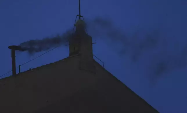 Black smoke billows from the chimney of the Sistine Chapel during the cardinals' conclave to elect a new pope, at the Vatican, Wednesday, May 7, 2025. (AP Photo/Alessandra Tarantino)