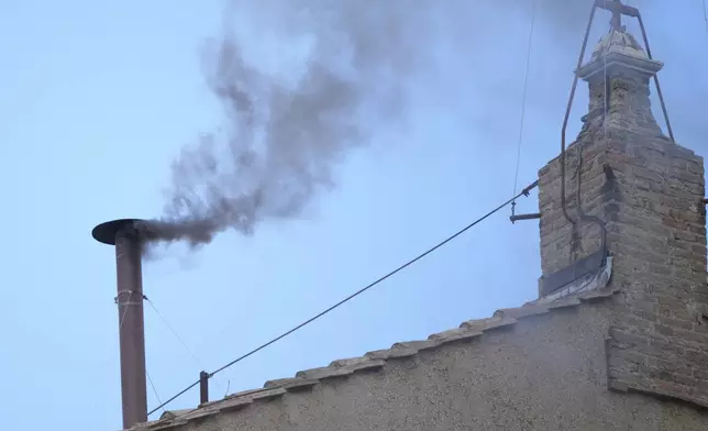 Black smoke billows from the chimney of the Sistine Chapel during the conclave to elect a new pope, at the Vatican, Thursday, May 8, 2025. (AP Photo/Andrew Medichini)