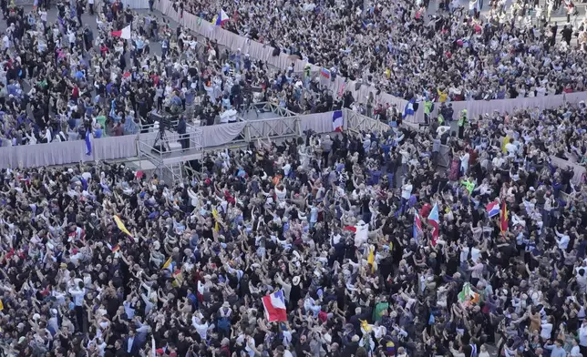 People watch as white smoke billows from the chimney of the Sistine Chapel where 133 cardinals are gathering on the second day of the conclave to elect a successor to late Pope Francis, at the Vatican, Thursday, May 8, 2025 (AP Photo/Markus Schreiber)