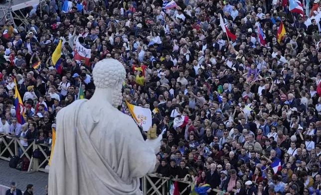 Crowds cheer in St. Peter's square after the election of the 267th pontiff of the Roman Catholic Church, at the Vatican, Thursday, May 8, 2025. (AP Photo/Gregorio Borgia)
