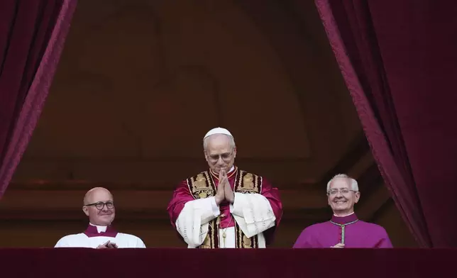 Newly elected Pope Leo XIV appears at the balcony of St. Peter's Basilica at the Vatican, Thursday, May 8, 2025. (AP Photo/Alessandra Tarantino)