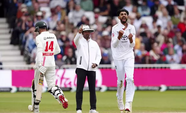 England's Shoaib Bashir, right, celebrates taking the wicket of Zimbabwe's Sean Williams on day three of the Rothesay International Test match between England and Zimbabwe at Trent Bridge, Nottingham, England, Saturday, May 24, 2025. (Mike Egerton/PA via AP)