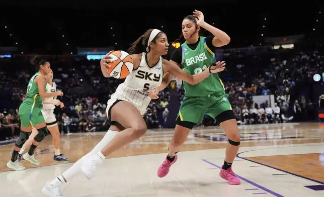 Chicago Sky forward Angel Reese (5) drives to the basket against Brazil forward Manu Alves in the second half a WNBA exhibition basketball game in Baton Rouge, La., Friday, May 2, 2025. (AP Photo/Gerald Herbert)