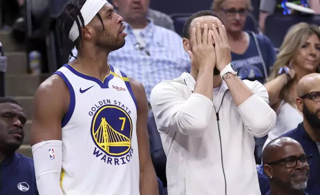 Golden State Warriors' Stephen Curry, right, and Buddy Hield react to a missed shot in the second half of Game 5 of an NBA basketball second-round playoff series, Wednesday, May 14, 2025, in Minneapolis. (Scott Strazzante/San Francisco Chronicle via AP)