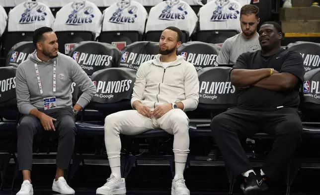Golden State Warriors guard Stephen Curry, middle, sits before Game 5 of an NBA basketball second-round playoff series against the Minnesota Timberwolves, Wednesday, May 14, 2025, in Minneapolis. (AP Photo/Abbie Parr)