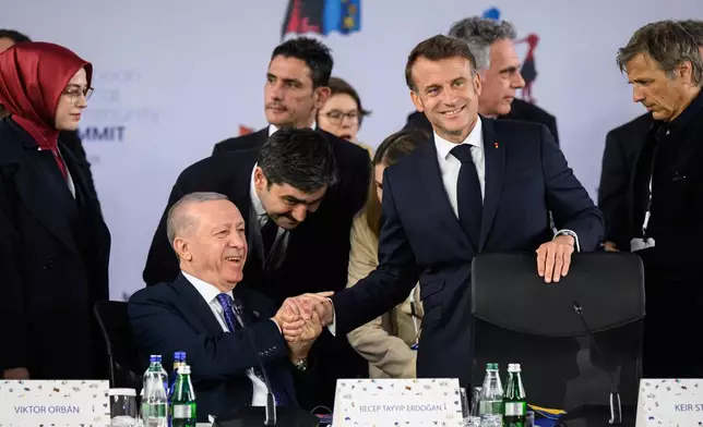 Turkish President Recep Tayyip Erdogan, left, talks with President of France Emmanuel Macron, right, ahead of a summit where the leaders of 47 European countries and organizations will discuss security, defense and democratic standards, in Tirana, Albania, Friday, May 16, 2025. (Leon Neal/Pool via AP)