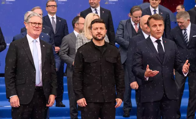 Britain's Prime Minister Keir Starmer, left, Ukraine's President Volodymyr Zelenskyy and France's President Emmanuel Macron, right, during a group photo at the beginning of a summit where the leaders of 47 European countries and organizations will discuss security, defense and democratic standards, in Tirana, Albania, Friday, May 16, 2025. (Leon Neal/Pool via AP)