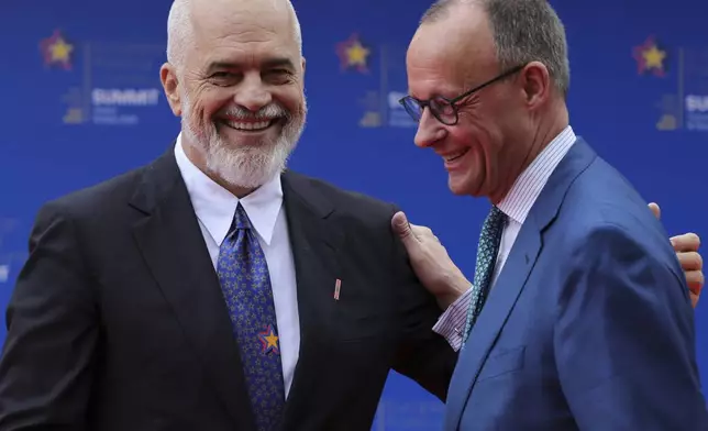 Albanian Prime Minister Edi Rama, left, welcomes Germany's Federal Chancellor Friedrich Merz ahead of a summit where the leaders of 47 European countries and organizations will discuss security, defense and democratic standards against the backdrop of Russia's war on Ukraine, in Tirana, Albania, Friday, May 16, 2025. (AP Photo/Vlasov Sulaj)
