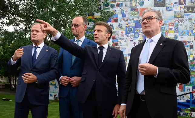 From left, Poland's Prime Minister Donald Tusk, Germany's Chancellor Friedrich Merz, France's President Emmanuel Macron and Britain's Prime Minister Keir Starmer talk to the press after their meeting Friday May 16, 2025 in Tirana, Albania. (Leon Neal/Pool via AP)