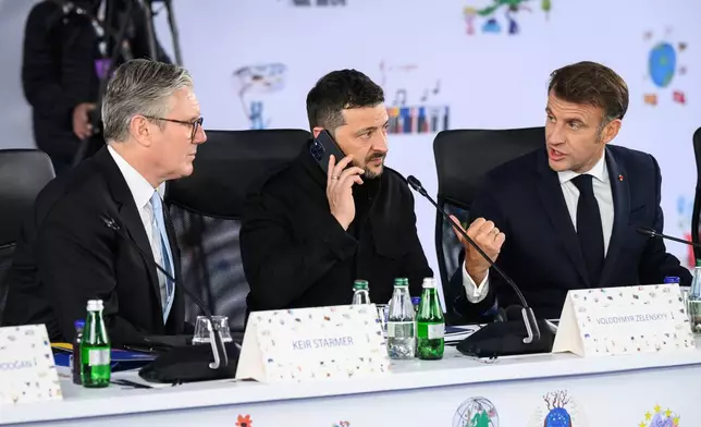 Britain's Prime Minister Keir Starmer, left, Ukraine's President Volodymyr Zelenskyy and France's President Emmanuel Macron, right, attend a plenary meeting at the beginning of a summit where the leaders of 47 European countries and organizations will discuss security, defense and democratic standards, in Tirana, Albania, Friday, May 16, 2025. (Leon Neal/Pool via AP)