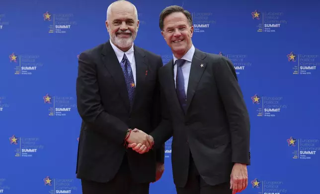 Albanian Prime Minister Edi Rama, left, welcomes NATO Secretary General Mark Rutte ahead of a summit where the leaders of 47 European countries and organizations will discuss security, defense and democratic standards against the backdrop of Russia's war on Ukraine, in Tirana, Albania, Friday, May 16, 2025. (AP Photo/Vlasov Sulaj)
