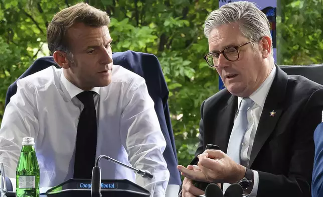 France's President Emmanuel Macron, left, and Britain's Prime Minister Keir Starmer speak during the Ukraine security meeting at the 6th European Political Community summit Friday May 16, 2025 in Tirana, Albania. (Leon Neal/Pool via AP)