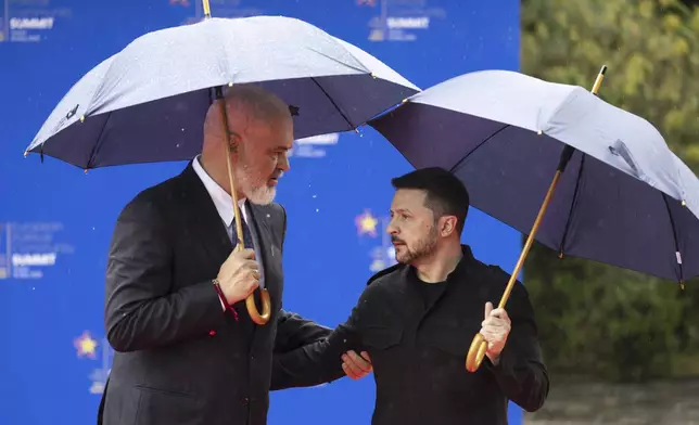 Albania's Prime Minister Edi Rama, left, welcomes President of Ukraine Volodymyr Zelenskyy at the 6th European Political Community (EPC) Summit in Tirana, Albania, Friday, May 16, 2025. (Peter Klaunzer/Keystone via AP)