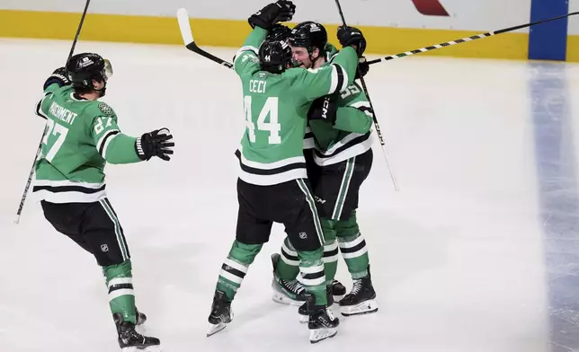 Dallas Stars' Mason Marchment (27), Cody Ceci (44) and Thomas Harley, right, celebrate Harley's goal in overtime of Game 6 of a second-round NHL hockey playoff series against the Winnipeg Jets in Dallas, Saturday, May 17, 2025. (AP Photo/Gareth Patterson)