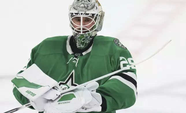 Dallas Stars goaltender Jake Oettinger warms up before Game 6 of a second-round NHL hockey playoff series against the Winnipeg Jets in Dallas, Saturday, May 17, 2025. (AP Photo/Gareth Patterson)