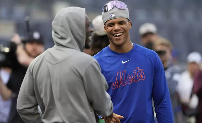 New York Mets' Juan Soto, right, talks with New York Yankees' Jazz Chisholm Jr. before a baseball game Friday, May 16, 2025, in New York. (AP Photo/Seth Wenig)