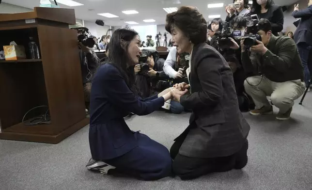 FILE - Truth and Reconciliation Commission Chairperson Park Sun Young, right, comforts adoptee Yooree Kim during a press conference in Seoul, South Korea, March 26, 2025. (AP Photo/Ahn Young-joon, File)