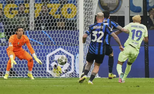 Barcelona's Lamine Yamal, right, attempts a shot at goal in front of Inter Milan's goalkeeper Yann Sommer, left, and Inter Milan's Federico Dimarco during the Champions League semifinal second leg soccer match between Inter Milan and Barcelona at San Siro stadium in Milan , Italy, Tuesday, May 6, 2025. (AP Photo/Luca Bruno)