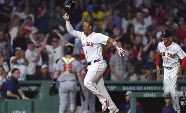 Boston Red Sox's Rafael Devers, left, celebrates as he runs the bases toward home after hitting a walkoff home run in the ninth inning of a baseball game against the Atlanta Braves, Saturday, May 17, 2025, in Boston. (AP Photo/Steven Senne)