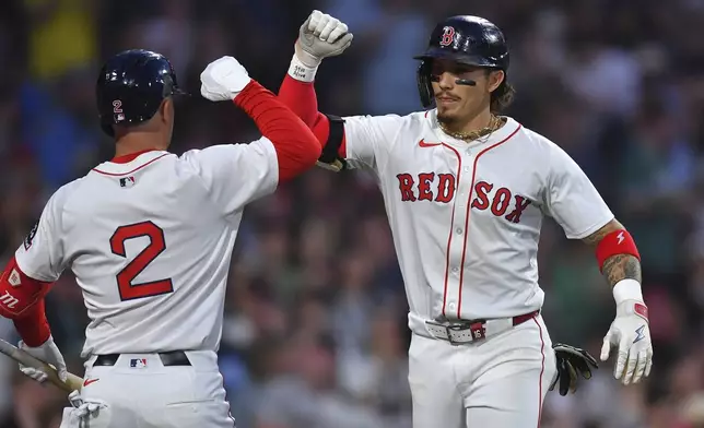 Boston Red Sox's Jarren Duran, right, celebrates after his two-run home run with Alex Bregman, left, in the third inning of a baseball game against the Atlanta Braves, Saturday, May 17, 2025, in Boston. (AP Photo/Steven Senne)