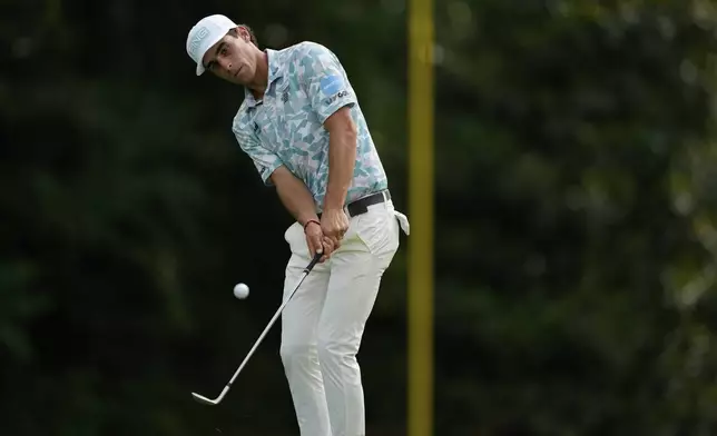 Joaquin Niemann chips to the green on the 12th hole during the first round of the PGA Championship golf tournament at the Quail Hollow Club, Thursday, May 15, 2025, in Charlotte, N.C. (AP Photo/Matt York)