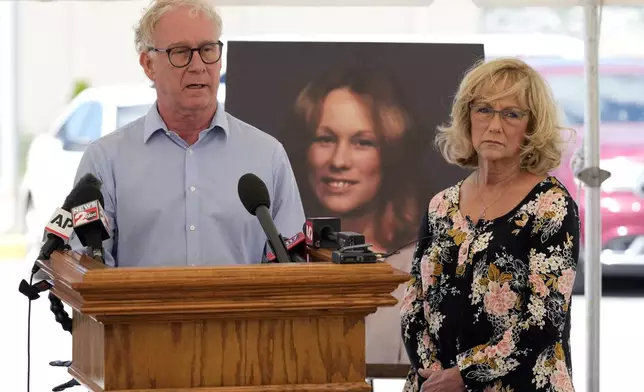 Mike Robirds, left, speaks as his sister, Terri Osborne, right, listens outside Riverbend Maximum Security Institution after the execution of Oscar Smith Thursday, May 22, 2025, in Nashville, Tenn. Robirds and Osborne are siblings of Judy Robirds, shown in the photograph between them, who was murdered along with her sons by Oscar Smith in 1989. (AP Photo/Mark Humphrey)