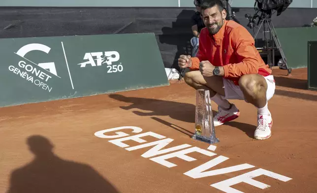 Winner Novak Djokovic of Serbia poses with the trophy after the final match of the ATP 250 Geneva Open tennis against Hubert Hurkacz of Poland, in Geneva, Switzerland, Saturday, May 24, 2025. (Martial Trezzini/Keystone via AP)