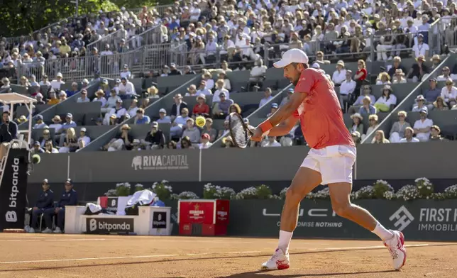 Novak Djokovic of Serbia returns a ball to Hubert Hurkacz of Poland during their final match of the ATP 250 Geneva Open tennis, in Geneva, Switzerland, Saturday, May 24, 2025. (Martial Trezzini/Keystone via AP)