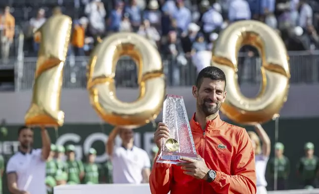 Winner Novak Djokovic of Serbia poses with the trophy after the final match of the ATP 250 Geneva Open tennis against Hubert Hurkacz of Poland, in Geneva, Switzerland, Saturday, May 24, 2025. (Martial Trezzini/Keystone via AP)