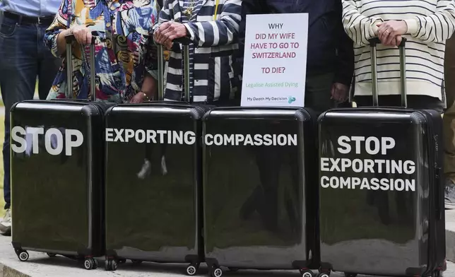 Pro-assisted dying campaigners gather outside Parliament ahead of Fridays report stage in the Commons on The Terminally Ill Adults (End of Life) Bill, which is expected to see MPs vote on further amendments, in Westminster in London, Thursday, May 15, 2025. (AP Photo/Kirsty Wigglesworth)