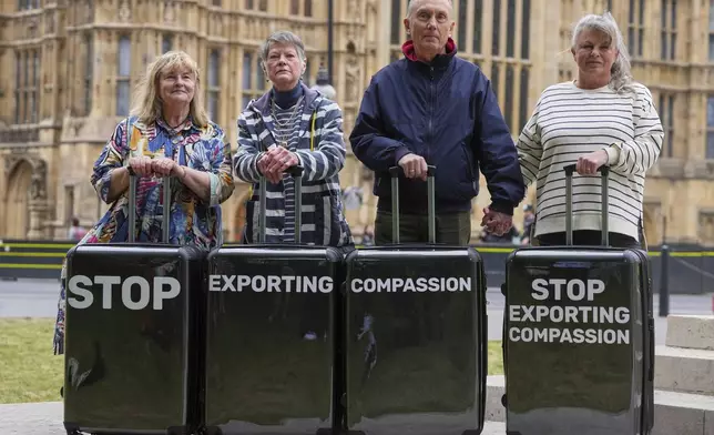 Pro-assisted dying campaigners Sue Lawford, left, Sara Starkey, second left, Dave Sowry, second right, and Louise Shackleton, right, gather outside Parliament ahead of Fridays report stage in the Commons on The Terminally Ill Adults (End of Life) Bill, which is expected to see MPs vote on further amendments, in Westminster in London, Thursday, May 15, 2025. (AP Photo/Kirsty Wigglesworth)