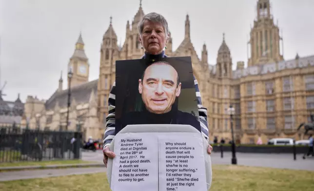 Pro-assisted dying campaigner Sara Starkey holds a picture of her late husband Andrew Tyler, outside Parliament ahead of Fridays report stage in the Commons on The Terminally Ill Adults (End of Life) Bill, which is expected to see MPs vote on further amendments, in Westminster in London, Thursday, May 15, 2025. (AP Photo/Kirsty Wigglesworth)
