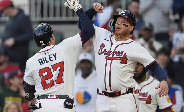 Atlanta Braves' Austin Riley (27) celebrates his two-run homer against the Los Angeles Dodgers in the third inning of a baseball game, Sunday, May 4, 2025, in Atlanta. (AP Photo/Mike Stewart)