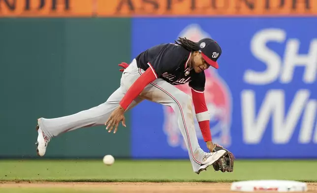 Washington Nationals shortstop CJ Abrams cannot reach a single by Philadelphia Phillies' J.T. Realmuto during the fourth inning of a baseball game, Wednesday, April 30, 2025, in Philadelphia. (AP Photo/Matt Slocum)