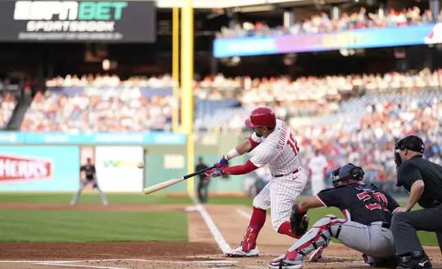 Philadelphia Phillies' Kyle Schwarber hits a three-run home run against Washington Nationals pitcher Jake Irvin during the first inning of a baseball game, Wednesday, April 30, 2025, in Philadelphia. (AP Photo/Matt Slocum)