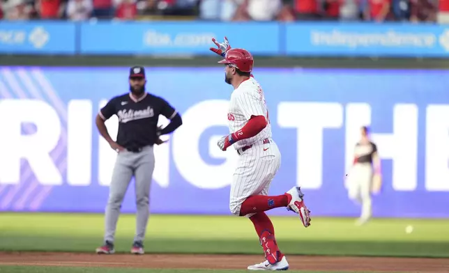Philadelphia Phillies' Kyle Schwarber, right, rounds the bases after hitting a three-run home run against Washington Nationals pitcher Jake Irvin during the first inning of a baseball game, Wednesday, April 30, 2025, in Philadelphia. (AP Photo/Matt Slocum)