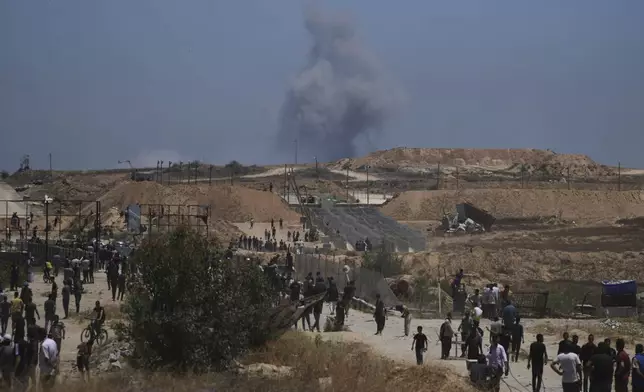Smoke rises following an Israeli bombardment in southern Gaza, as seen from a humanitarian aid distribution center operated by the U.S.-backed Gaza Humanitarian Foundation, approved by Israel, in Khan Younis, southern Gaza Strip, on Thursday, May 29, 2025. (AP Photo/Abdel Kareem Hana)