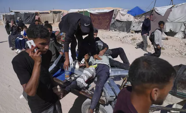 Palestinians carry an injured man after he was shot at an aid distribution center run by the Gaza Humanitarian Foundation a U.S.-backed organization approved by Israel in Khan Younis, southern Gaza Strip, on Thursday, May 29, 2025. (AP Photo/Abdel Kareem Hana)