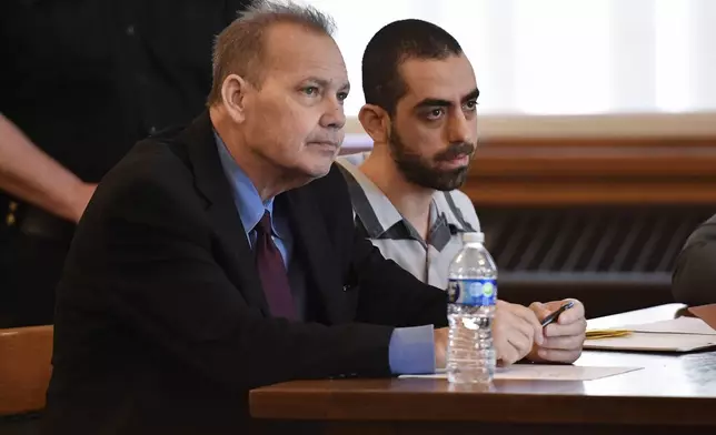 Hadi Matar, right, and public defender Nathaniel Barone listens to Chautauqua County Judge David Foley's sentence in Chautauqua County court in Mayville, N.Y., Friday, May. 16, 2025. (AP Photo/Adrian Kraus)