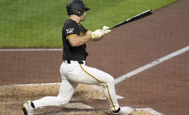 Pittsburgh Pirates' Bryan Reynolds singles off Cincinnati Reds pitcher Nick Martinez, driving in a run, during the sixth inning of a baseball game in Pittsburgh, Tuesday, May 20, 2025. (AP Photo/Gene J. Puskar)